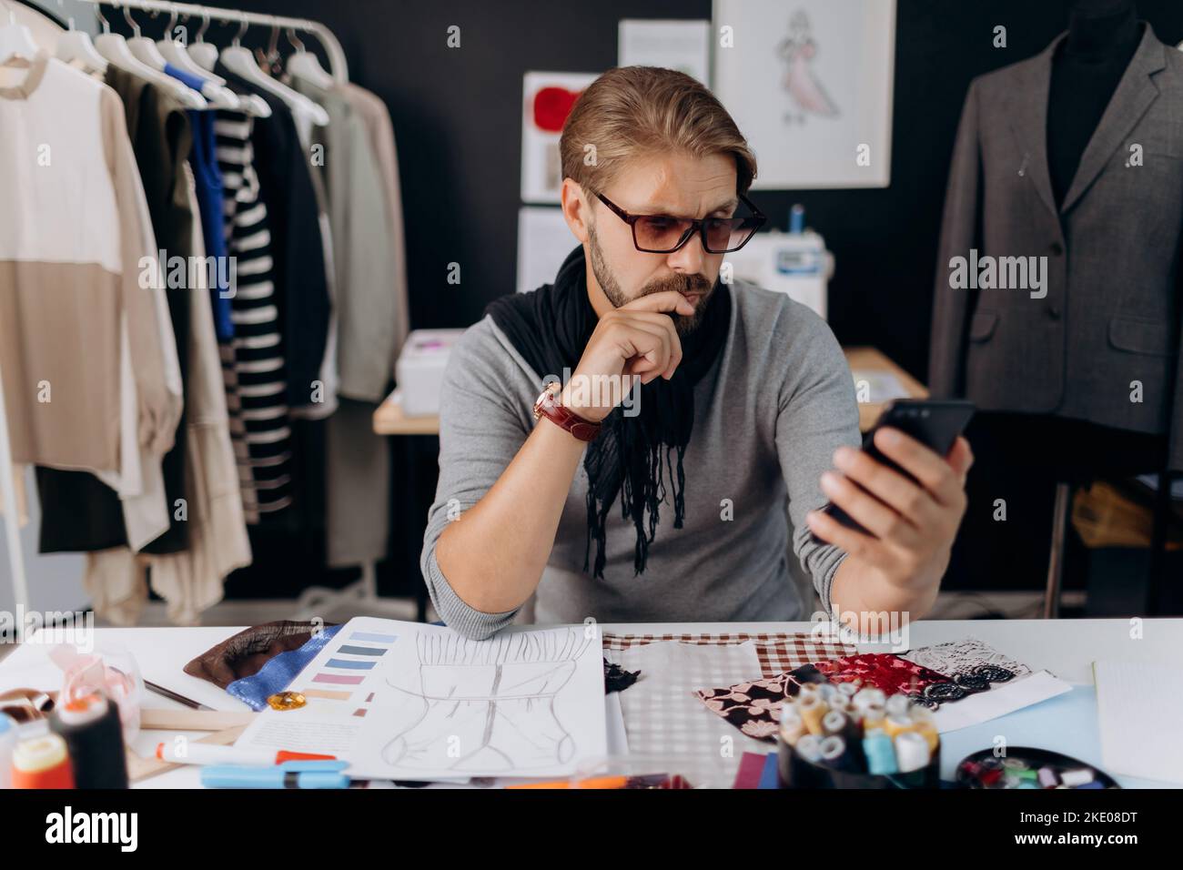 Designer using smartphone Stock Photo