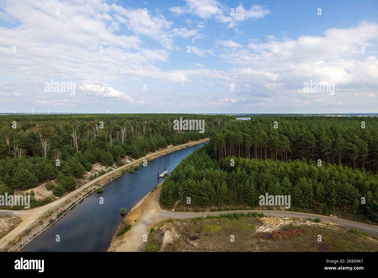 An aerial view of a river flowing in a forest surrounded by lush green ...
