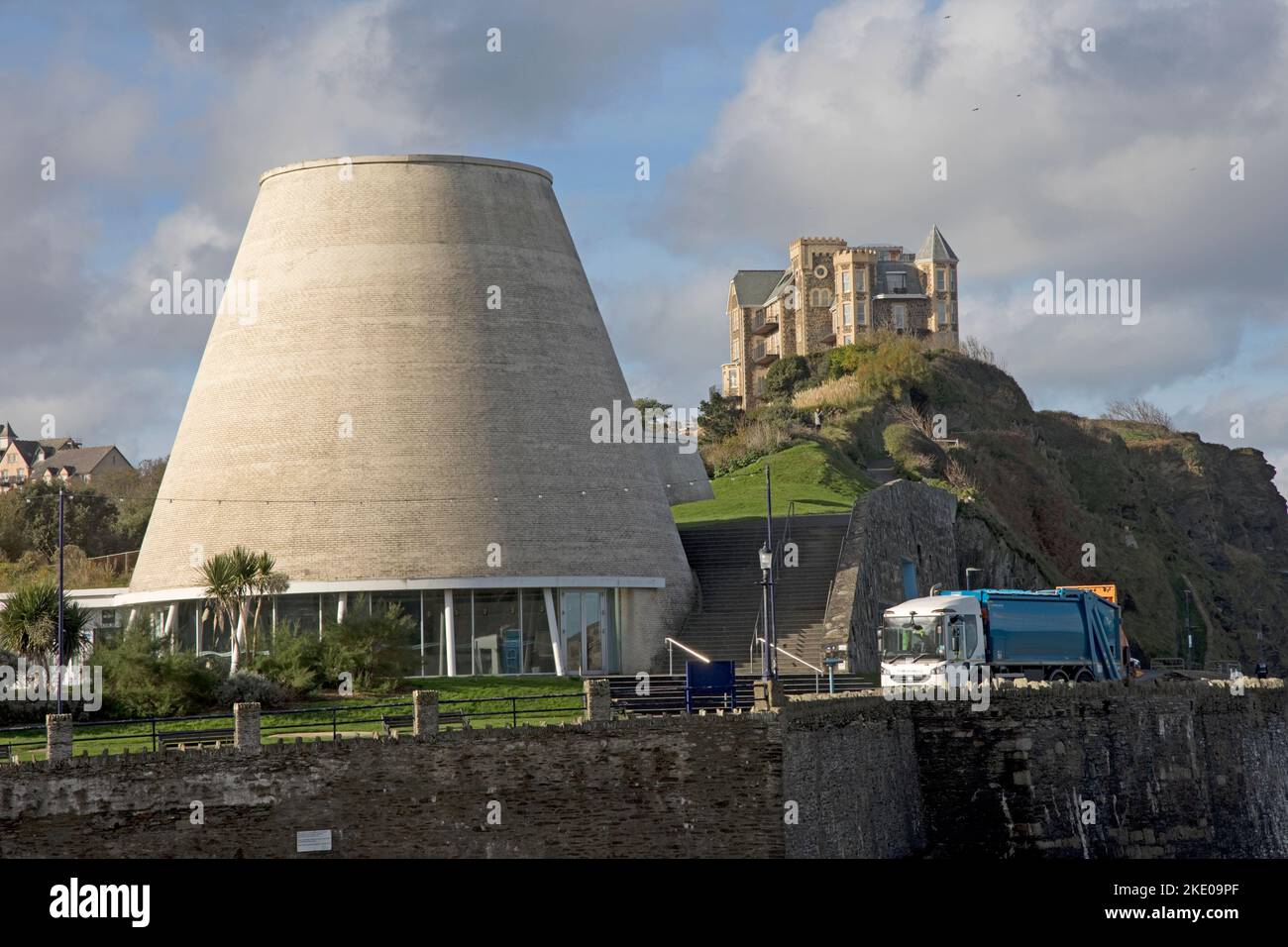 Two conical towers of the Landmark Theatre locally referred to as Madonna's Bra on the Promenade Ilfracombe with Granville Heights on the clifftop in Stock Photo