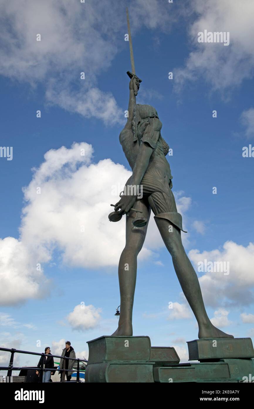 66 foot stainless steel and bronze sculpture named Verity, created by world famous artist Damien Hirst, stands on the pier at the entrance to the harb Stock Photo