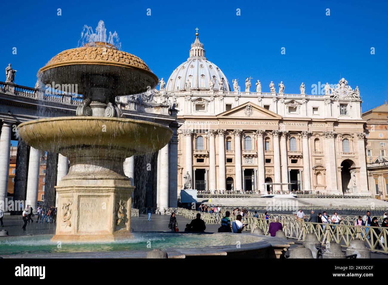 ITALY Lazio Rome Vatican City The Basilica of St Peter and the square or Piazza San Pietro with tourists around a water fountain in the foreground Stock Photo