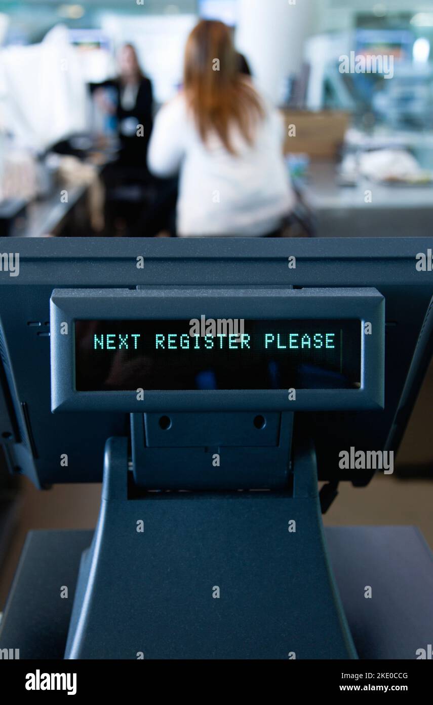 Ireland, County Dublin, Dublin City, Ballsbridge, Lansdowne Road, Aviva Stadium Unattended cash register with a digital readout that says Next Register Please with people in the background. Stock Photo