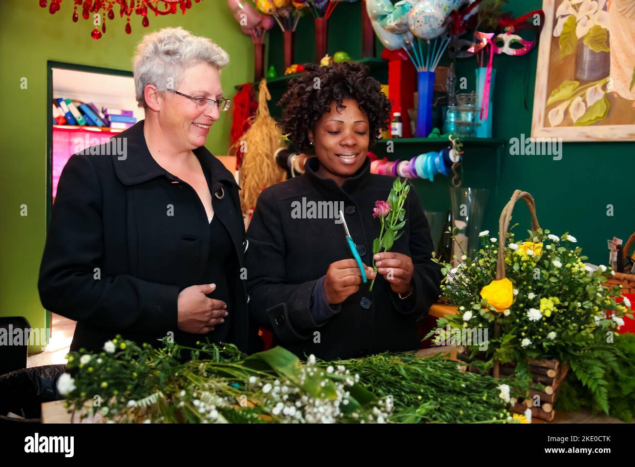 A small independent florist working happily at her retail store in