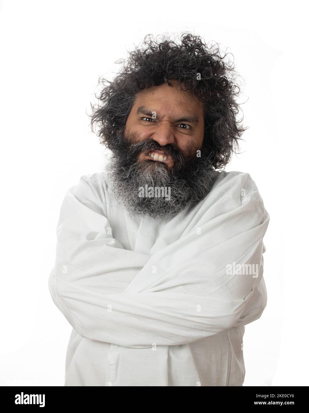 A vertical shot of a male psychopath with a weird facial expression in a straitjacket Stock Photo