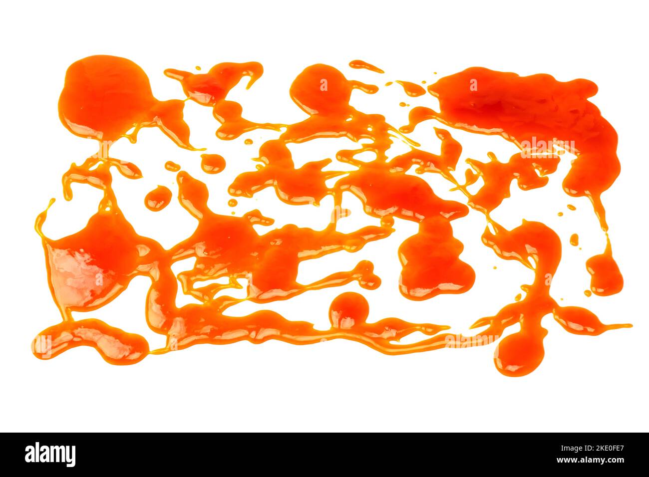 Orange sauce splashes isolated on white a background. Top view. Stock Photo