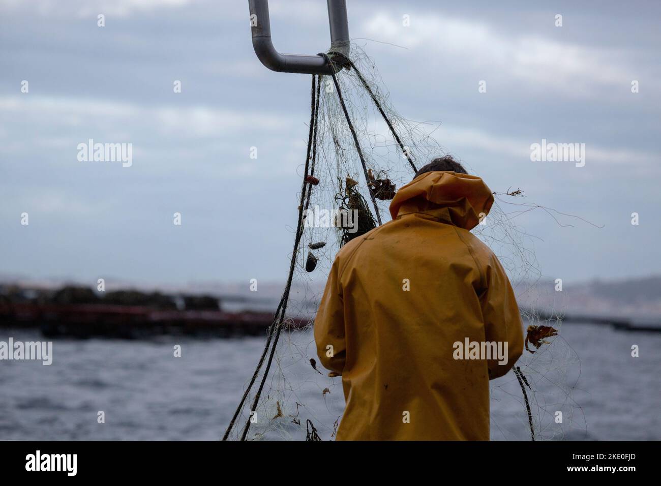 Inshore fishing sailors fish in their traditional wooden boat in the ...