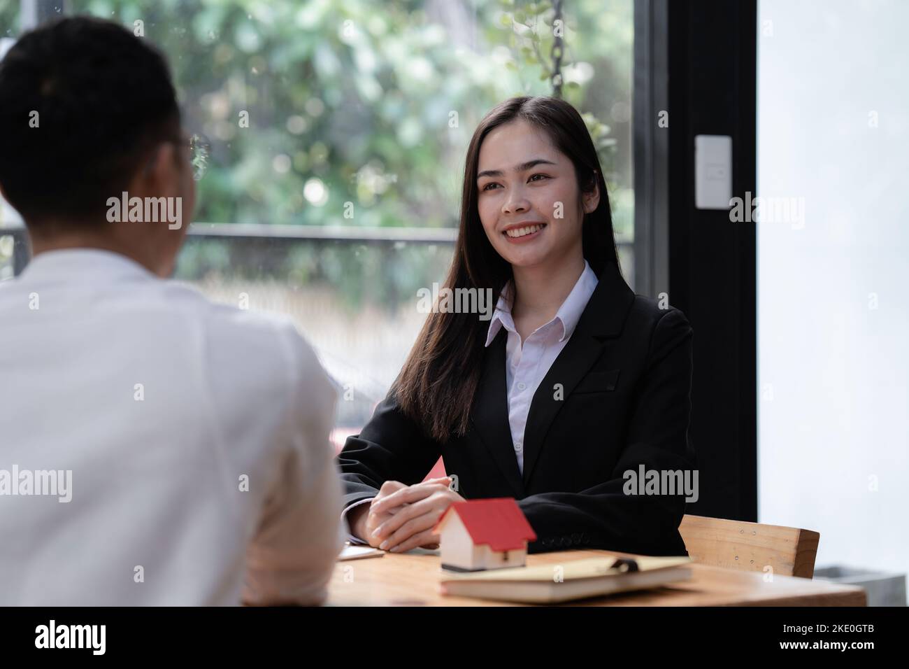 Close up Business woman or Real Estate agent explain signing agreement ...