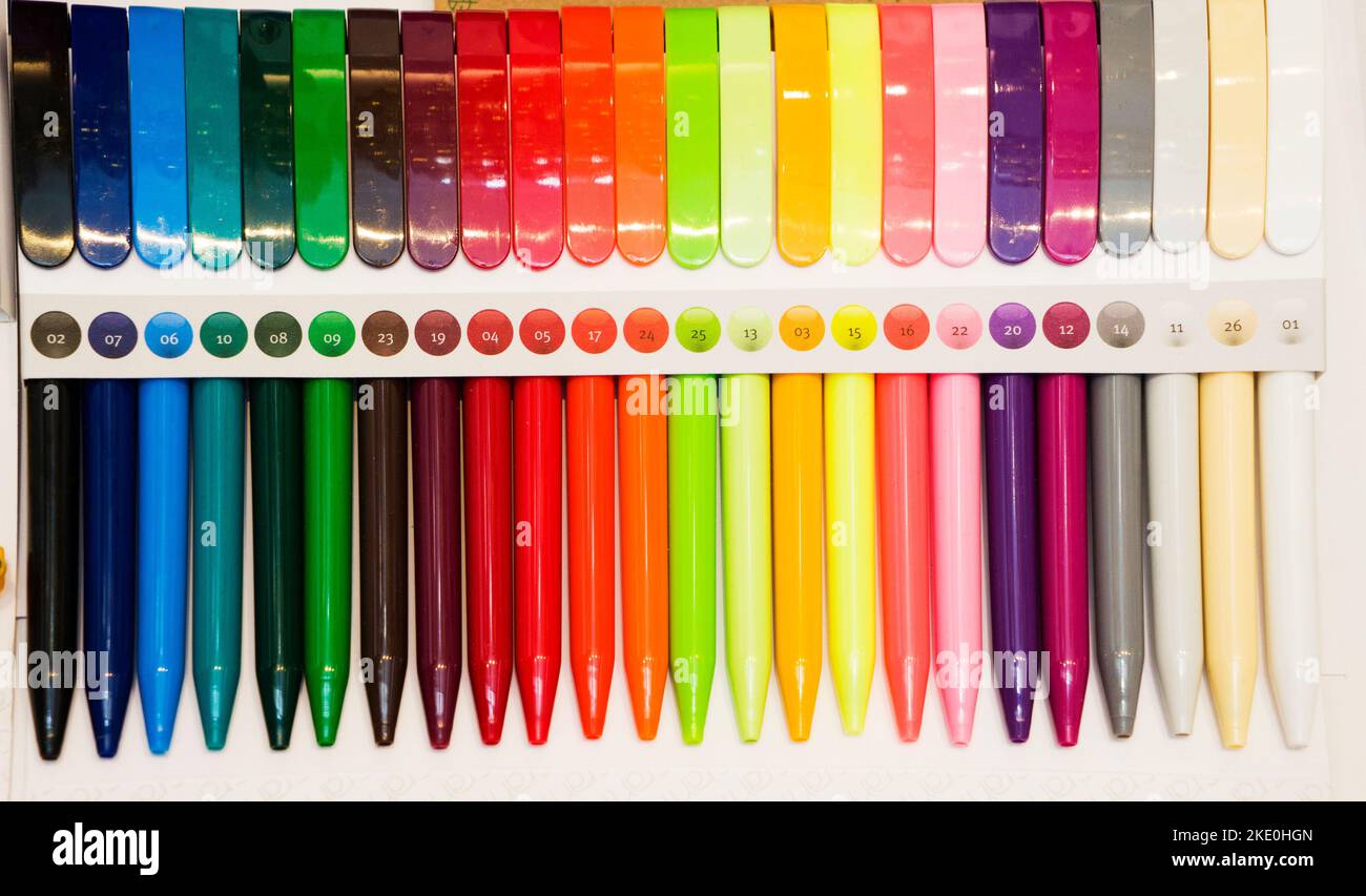a group multi-colored plastic ballpoint pens on white table Stock Photo ...