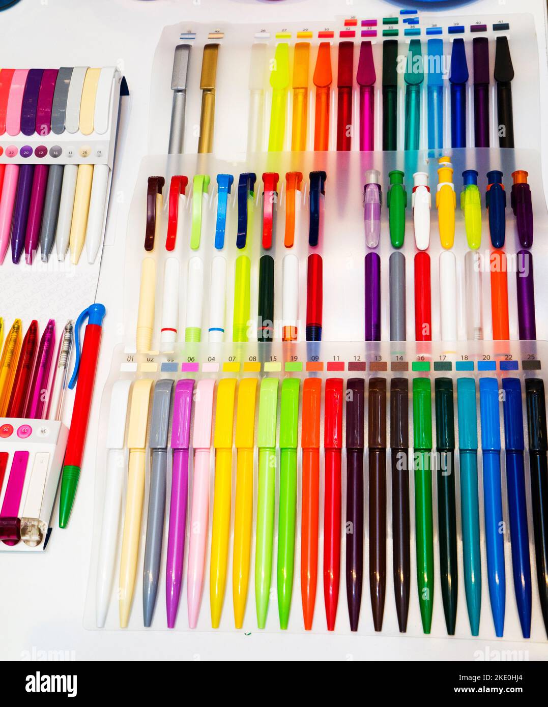 a group multi-colored plastic ballpoint pens on white table Stock Photo