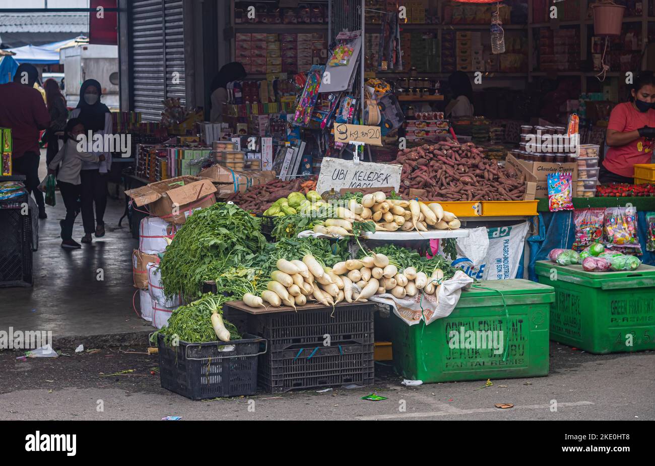 A stall selling white radish, sweet potatoes and other vegetables at a market in Cameron Highlands, Malaysia. Stock Photo