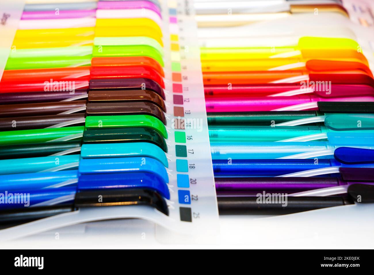 a group multi-colored plastic ballpoint pens on white table Stock Photo