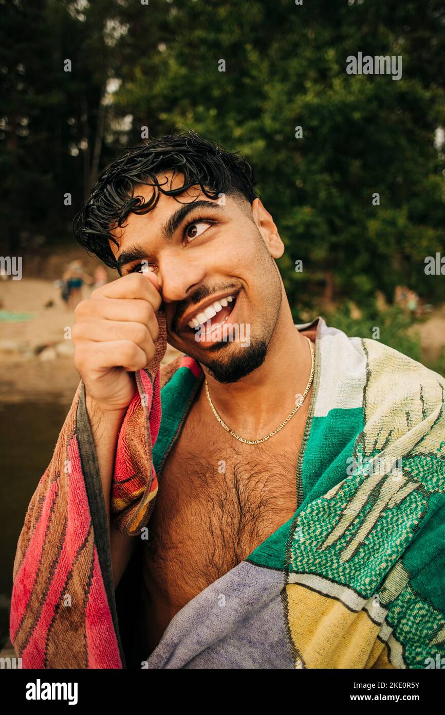 Smiling man looking away wearing towel Stock Photo