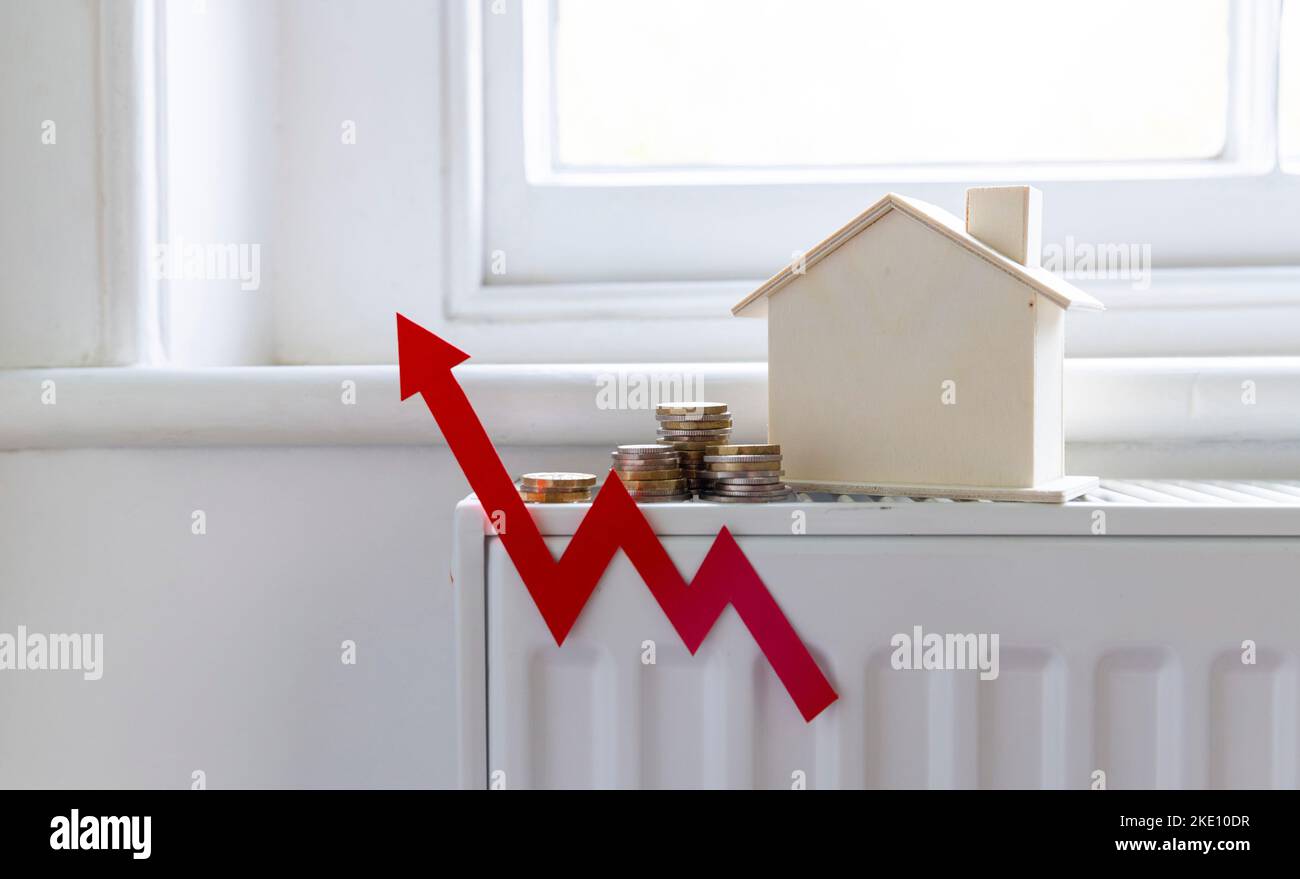 Home heating bills increase. Red up arrow with a house on a heating radiator Stock Photo