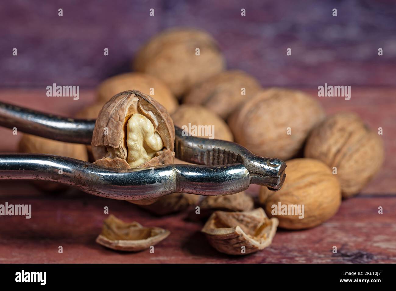 Walnuts and nutcracker in a close-up Stock Photo