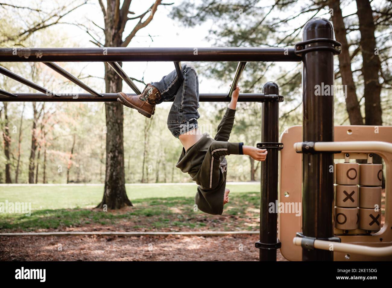 Young boy on playground bars hires stock photography and images Alamy
