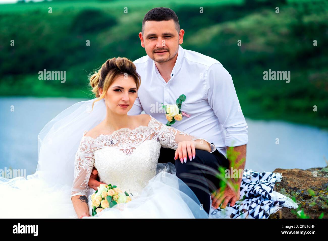 The bride and groom look at the camera when they are photographed Stock ...