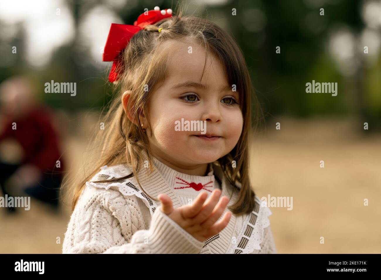 Outdoor portrait of an euphoric three years old little girl running