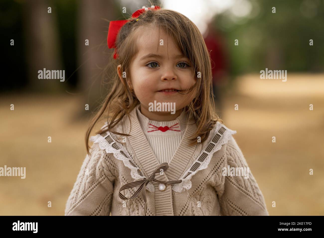 Outdoor portrait of an euphoric three years old little girl running