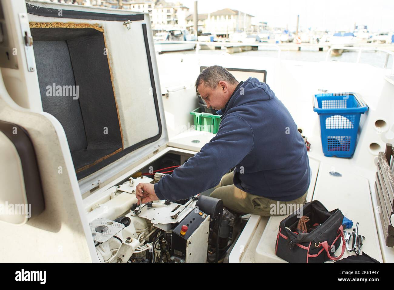 Boat mechanic repairing a ship engine Stock Photo Alamy