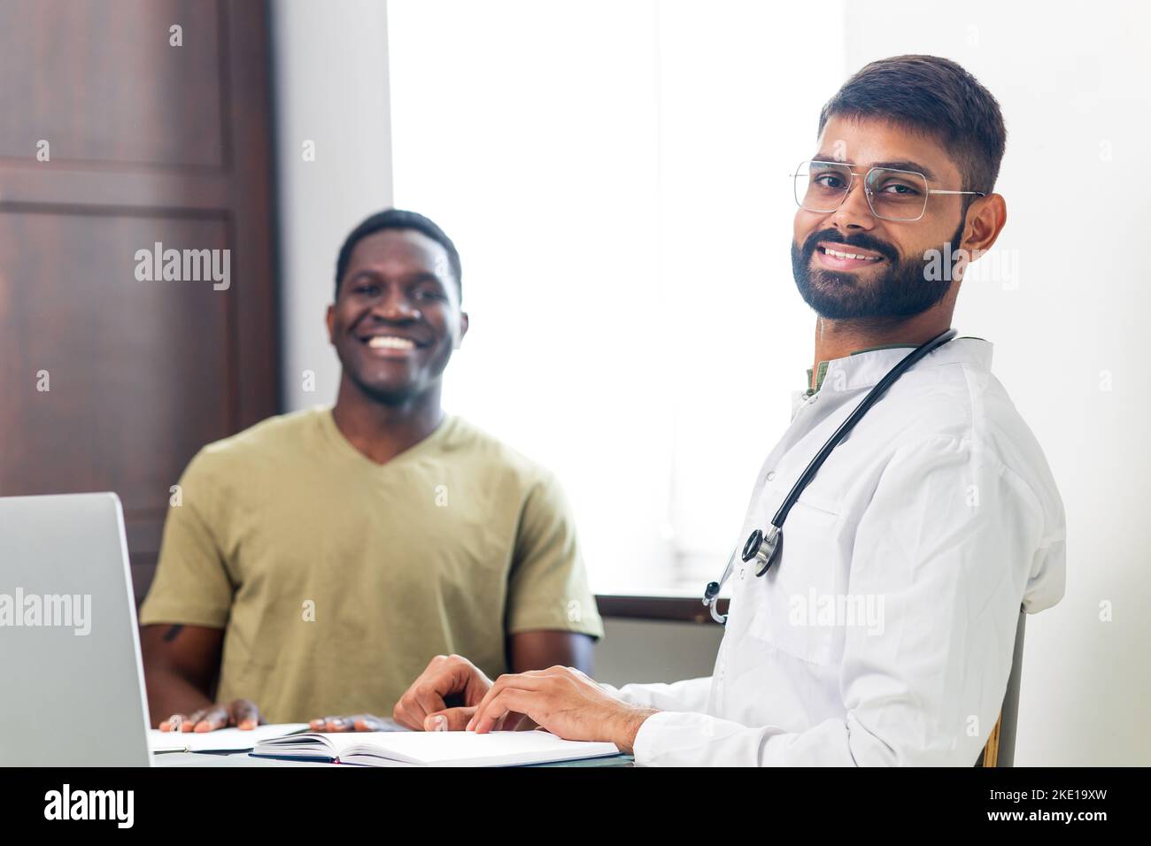 Indian doctor therapist in white coat consulting supporting patient in