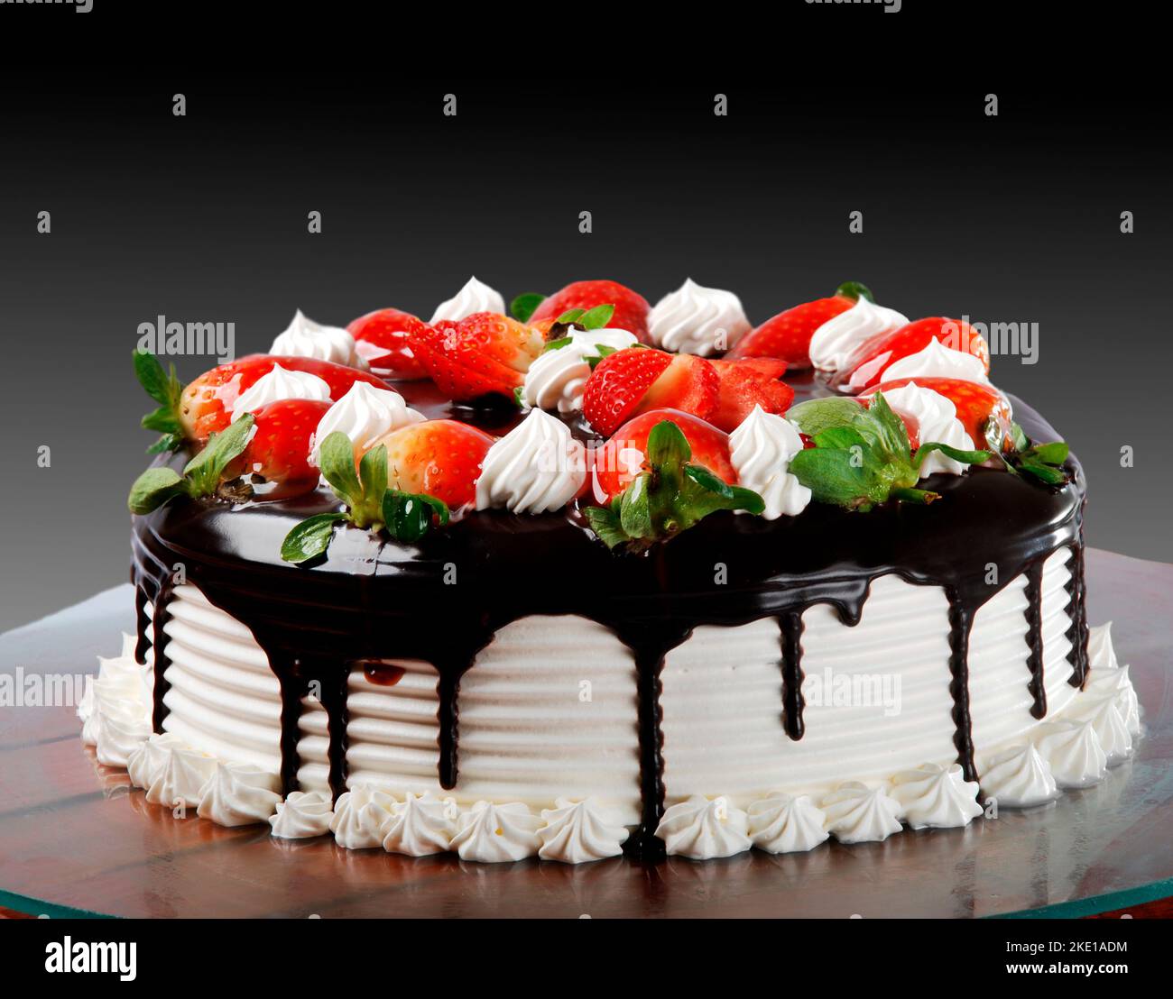 Cake with white chocolate icing, whipped cream and strawberries Stock ...