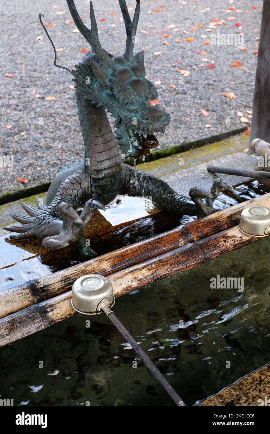 A sculpture of Japanese dragon in front of water basin at Saikyo-ji Buddhist temple in Shiga, Japan Stock Photo