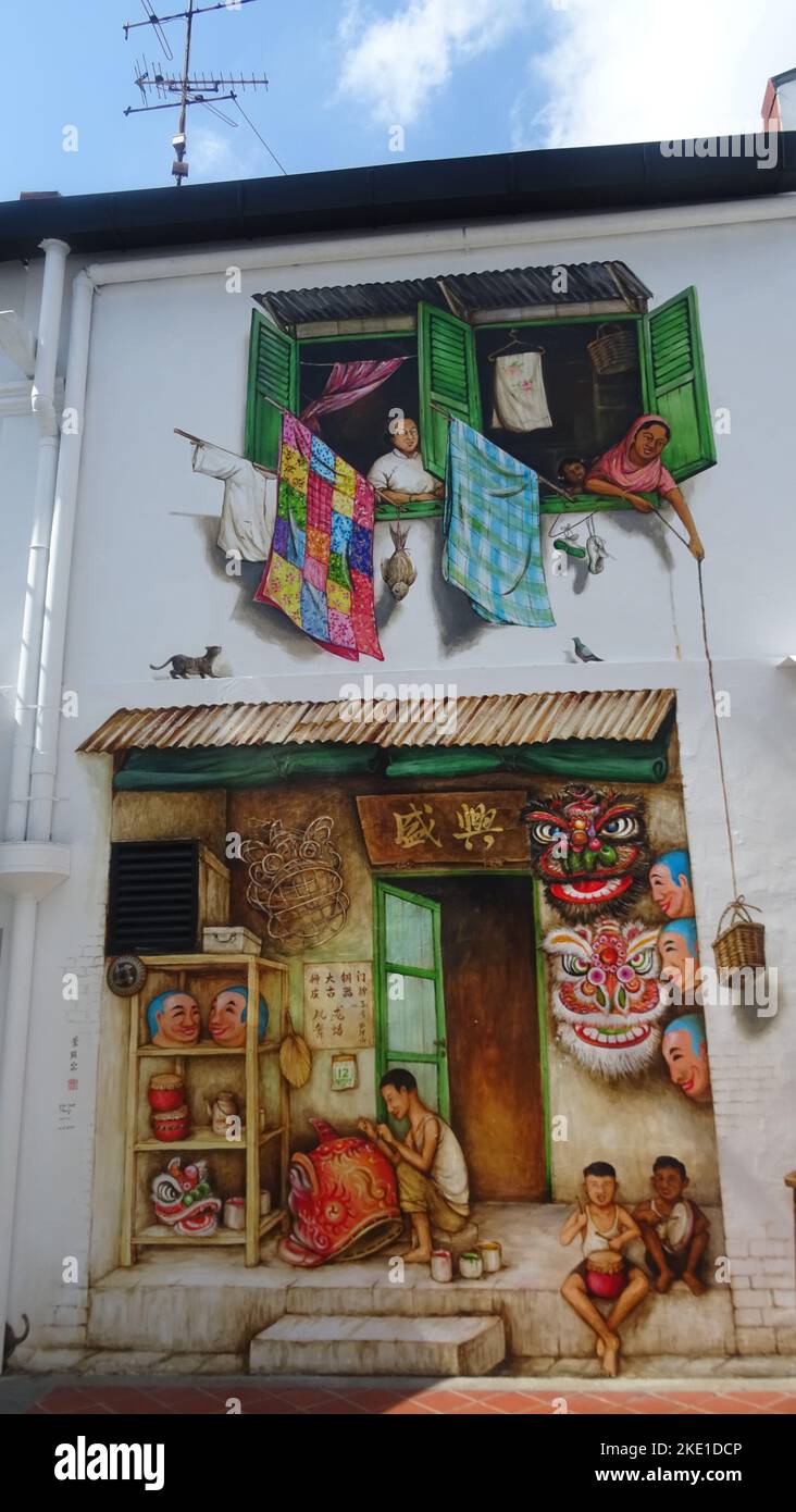 A vertical shot of mural art on a white building wall in Singapore