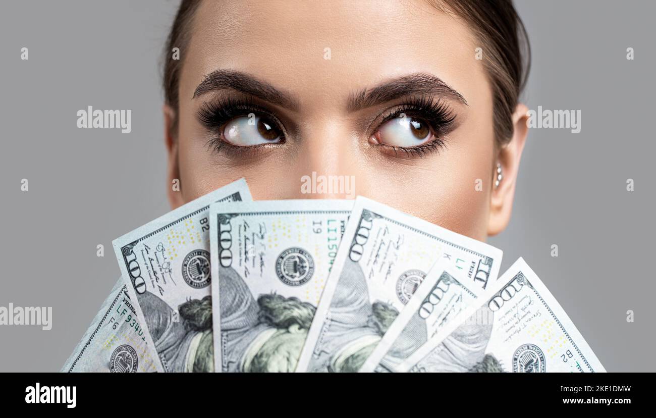 Woman with dollars in hand. Portrait woman holding money banknotes. Girl holding cash money in dollar banknotes. Woman holding lots of money in dollar Stock Photo