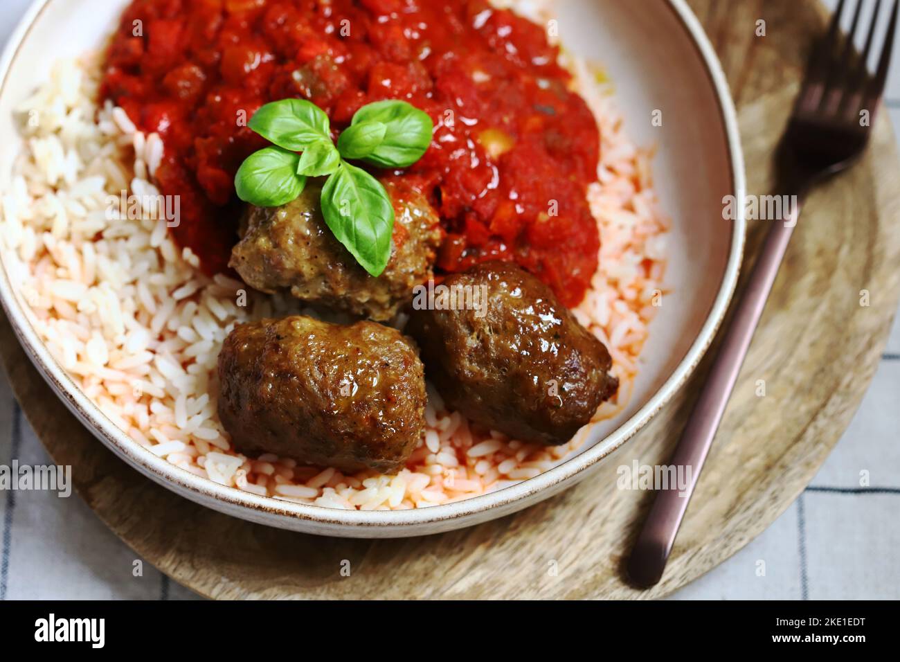 Rice with meatballs and tomato sauce. Stock Photo