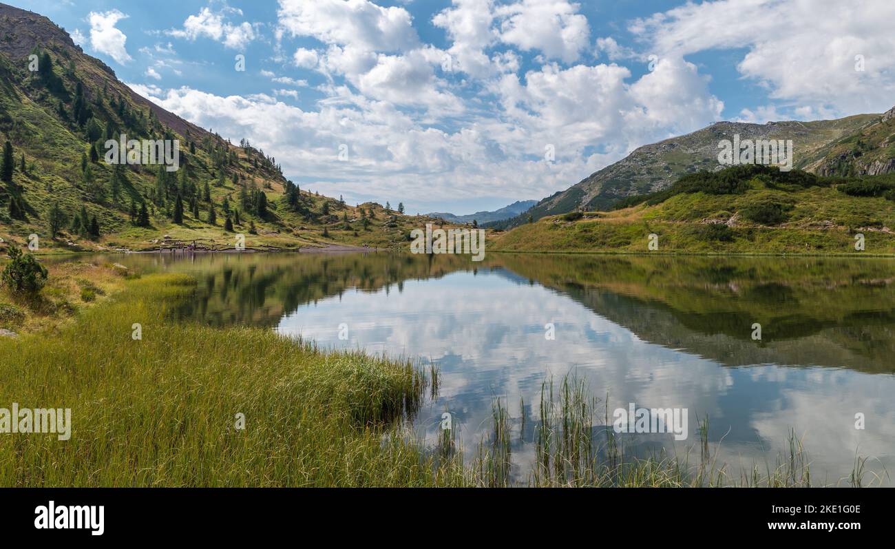 the Colbricon lakes in summer with the mountain reflected on the water ...