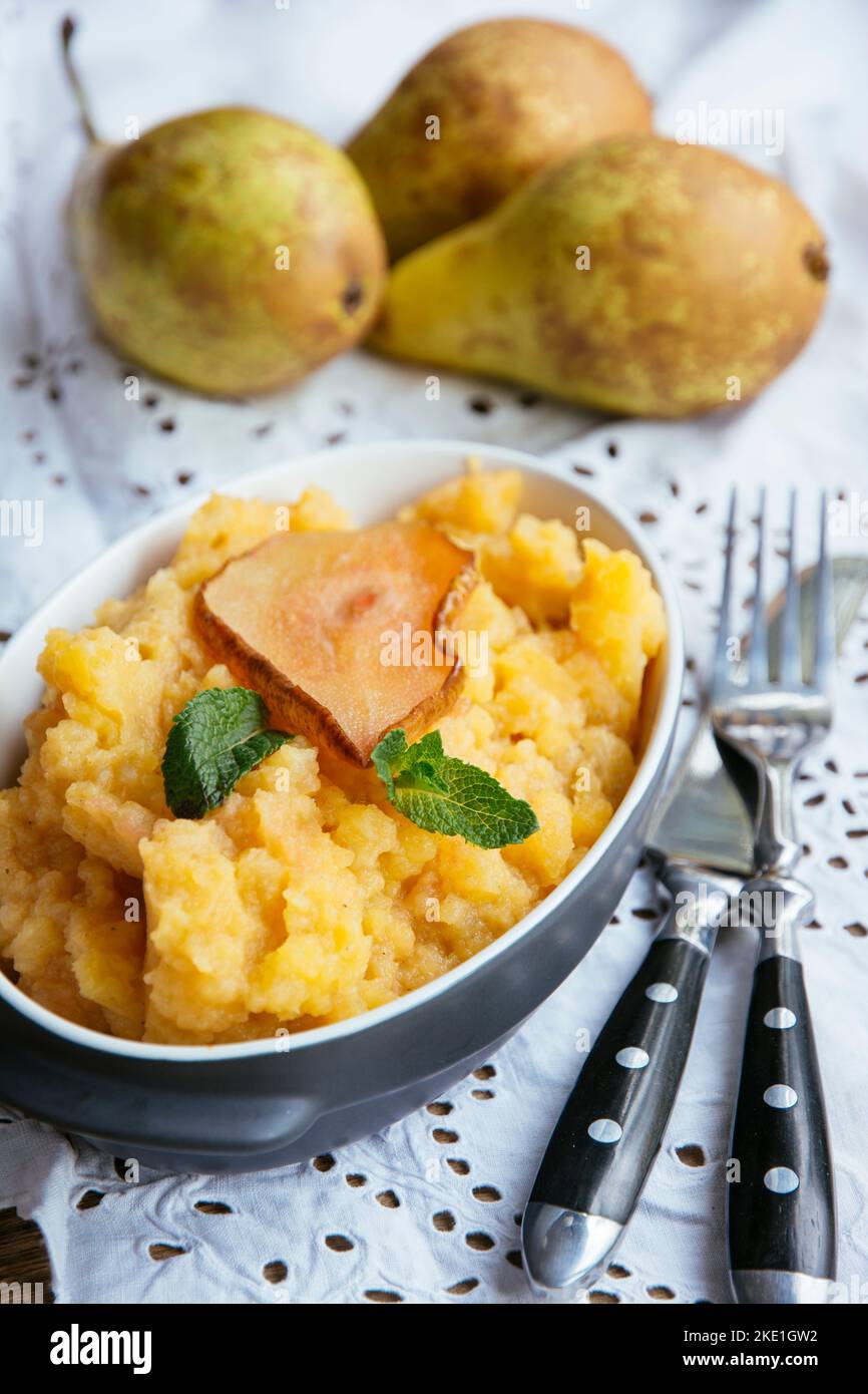 Homemade mashed rutabaga with roasted pears as side dish. Stock Photo