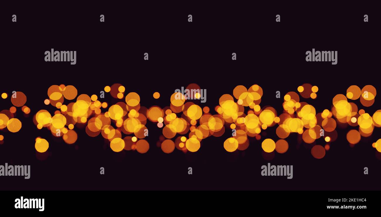 Golden abstract bokeh on black background. Stock Photo
