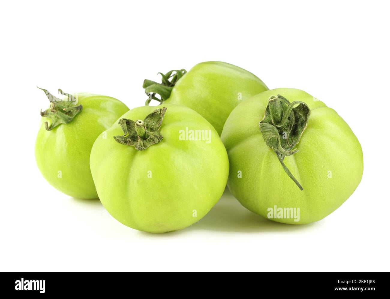 Group of green tomatoes isolated on white background Stock Photo