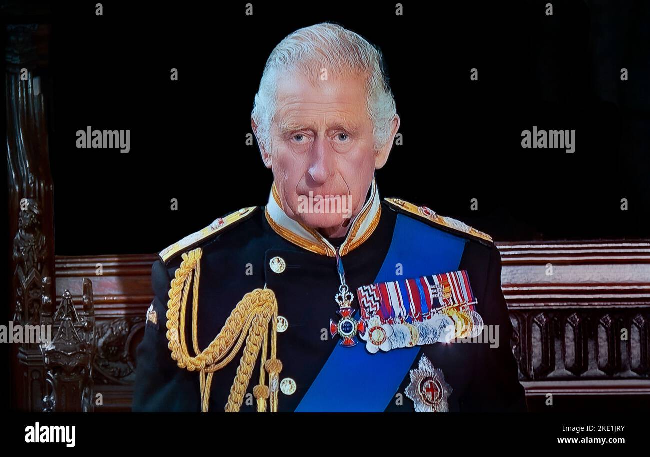 KING CHARLES III Portrait Queen Elizabeth II Funeral at Saint George’s Chapel Windsor Castle. A pensive sad reflective King Charles III during HM The Queen interior Royal Chapel funeral service at Windsor.  19th September 2022 (alt version black background) Stock Photo