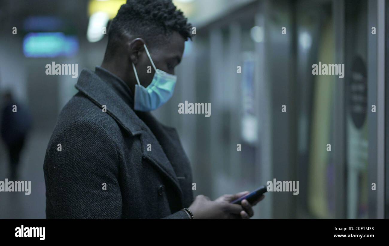 African man entering subway wagon wearing covid19 face mask in