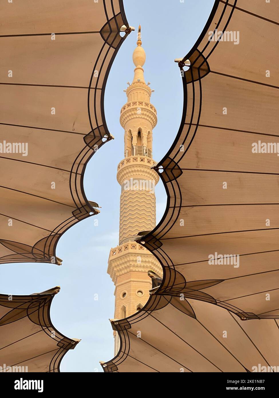 A vertical lowangle shot from under Shading Umbrellas of Medina Haram