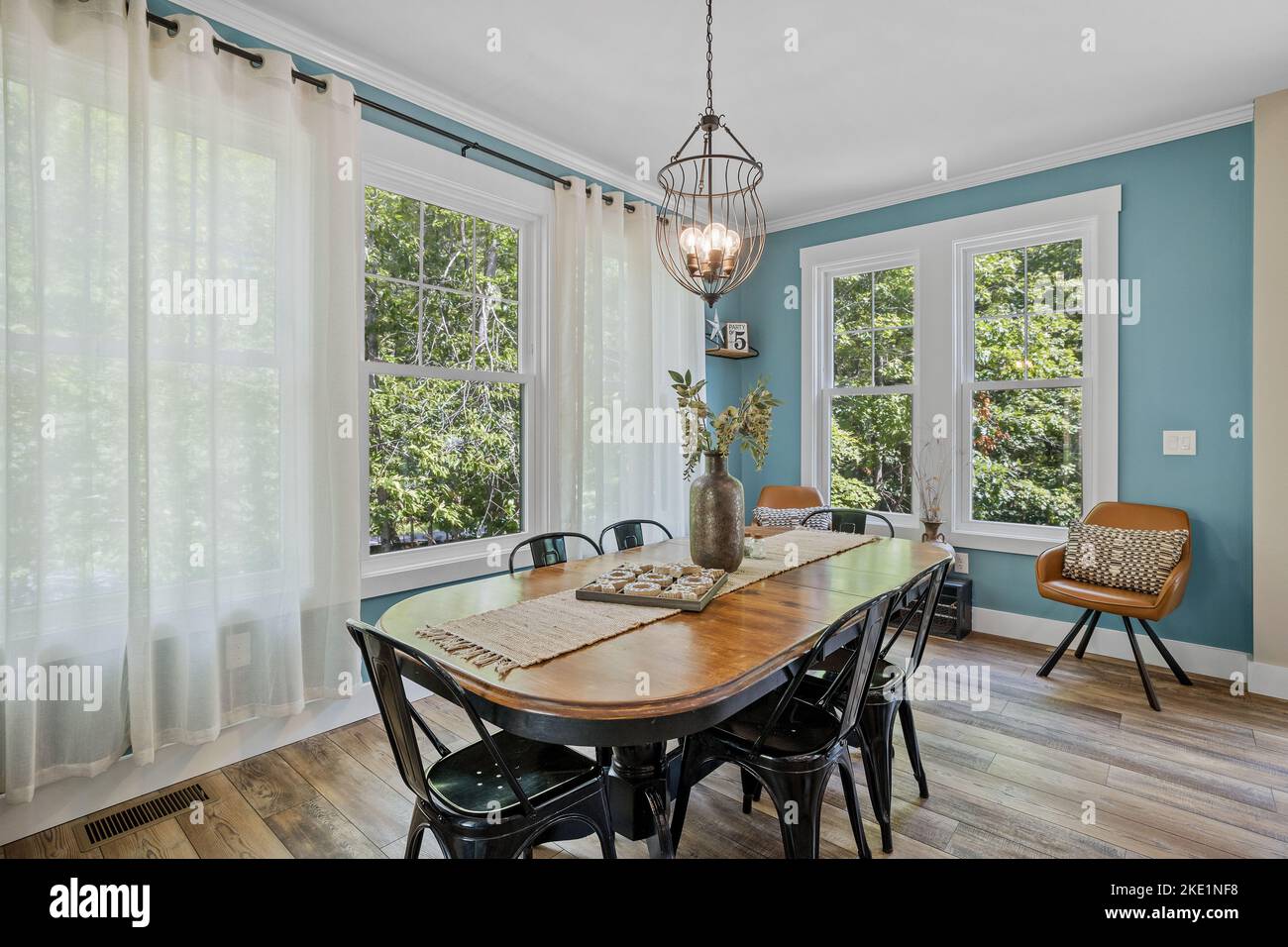 The interior design of a beautiful room with a dining table and blue
