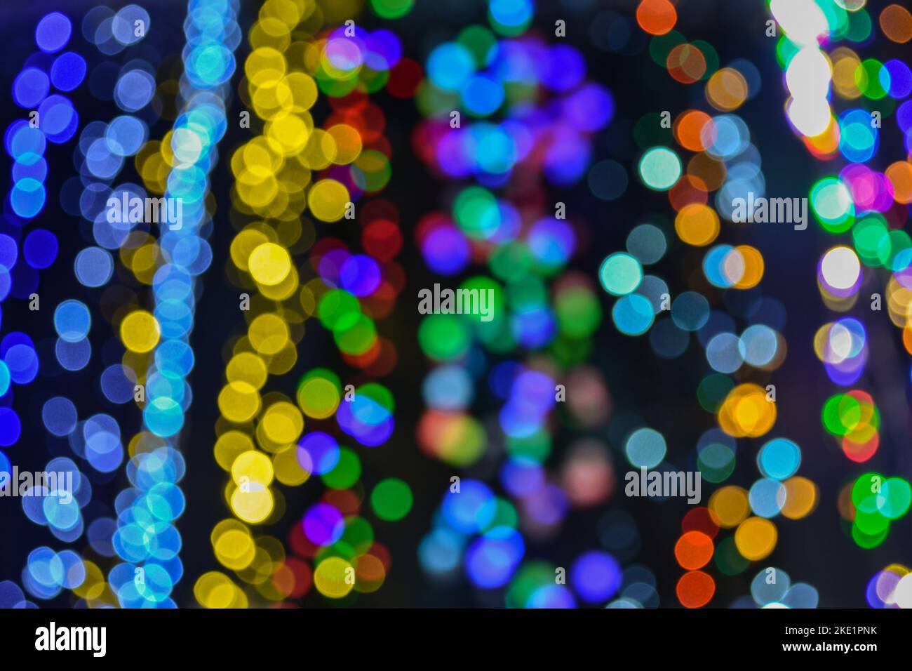 Blurred lights, colorful garland, bokeh, festive background. New year party concept Stock Photo