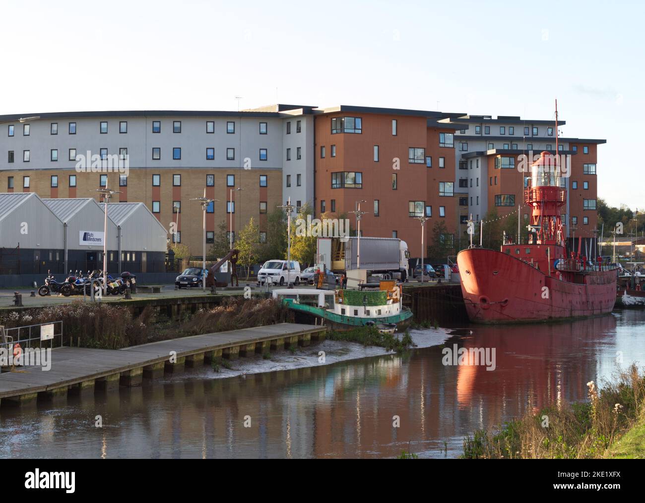 The Maltings student accommodation around Hythe Quay in Colchester, Essex with the TS Colne Lightship vessel moored in the River Colne. Stock Photo