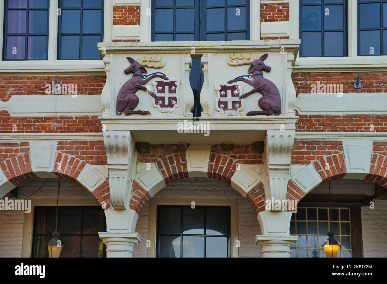 The town coat of arms, flanked by deer as shield holder, above the entrance to the 17th-century town hall of Vollenhove, the Netherlands. Stock Photo