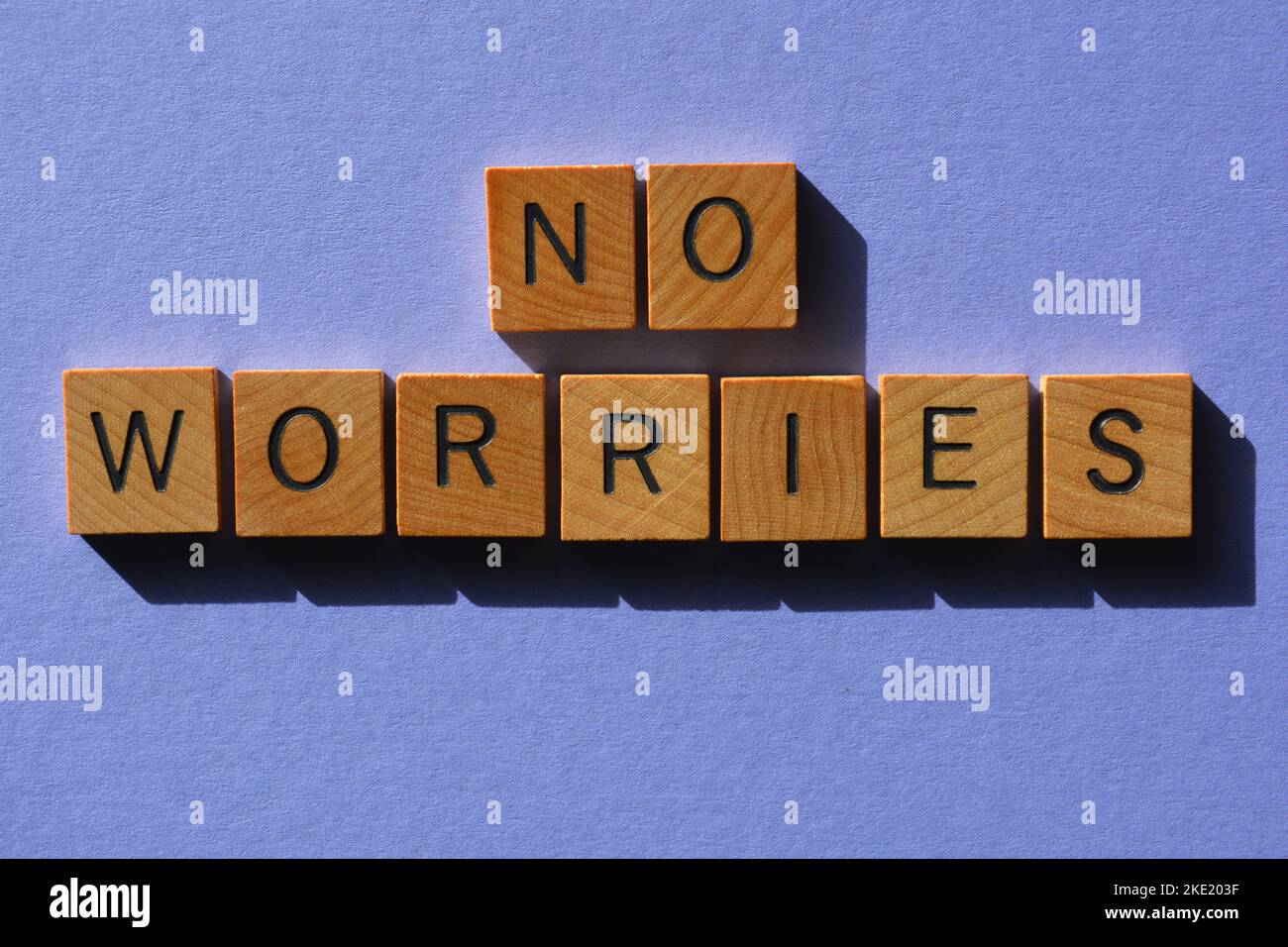 No Worries, Australian slang words meaning No Problem in wooden alphabet letters isolated on purple background Stock Photo