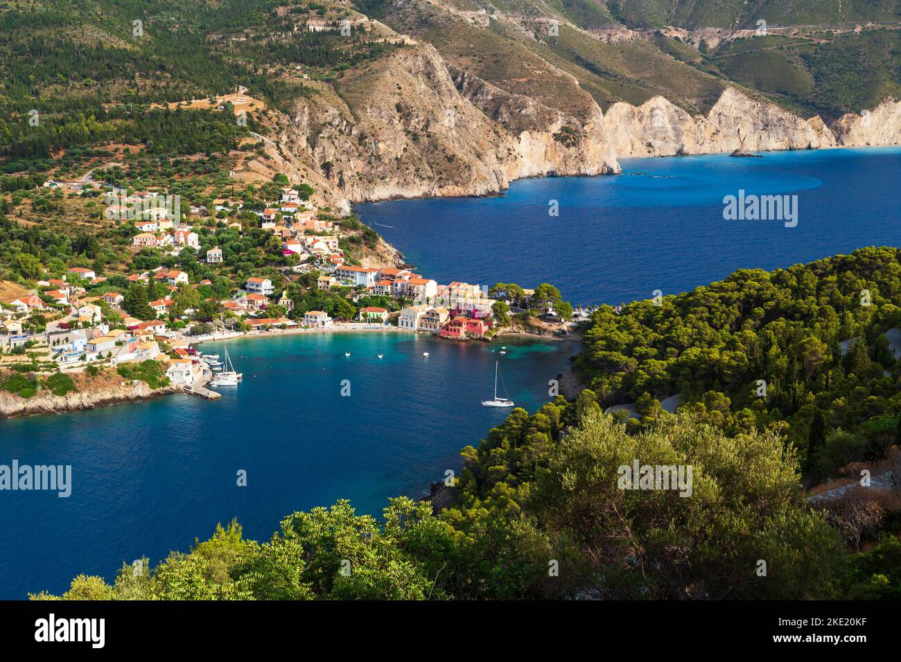 Fantastic top view at Asos village, Assos peninsula and blue Ionian Sea water. Aerial view, summer scenery of famous and extremely popular travel dest Stock Photo