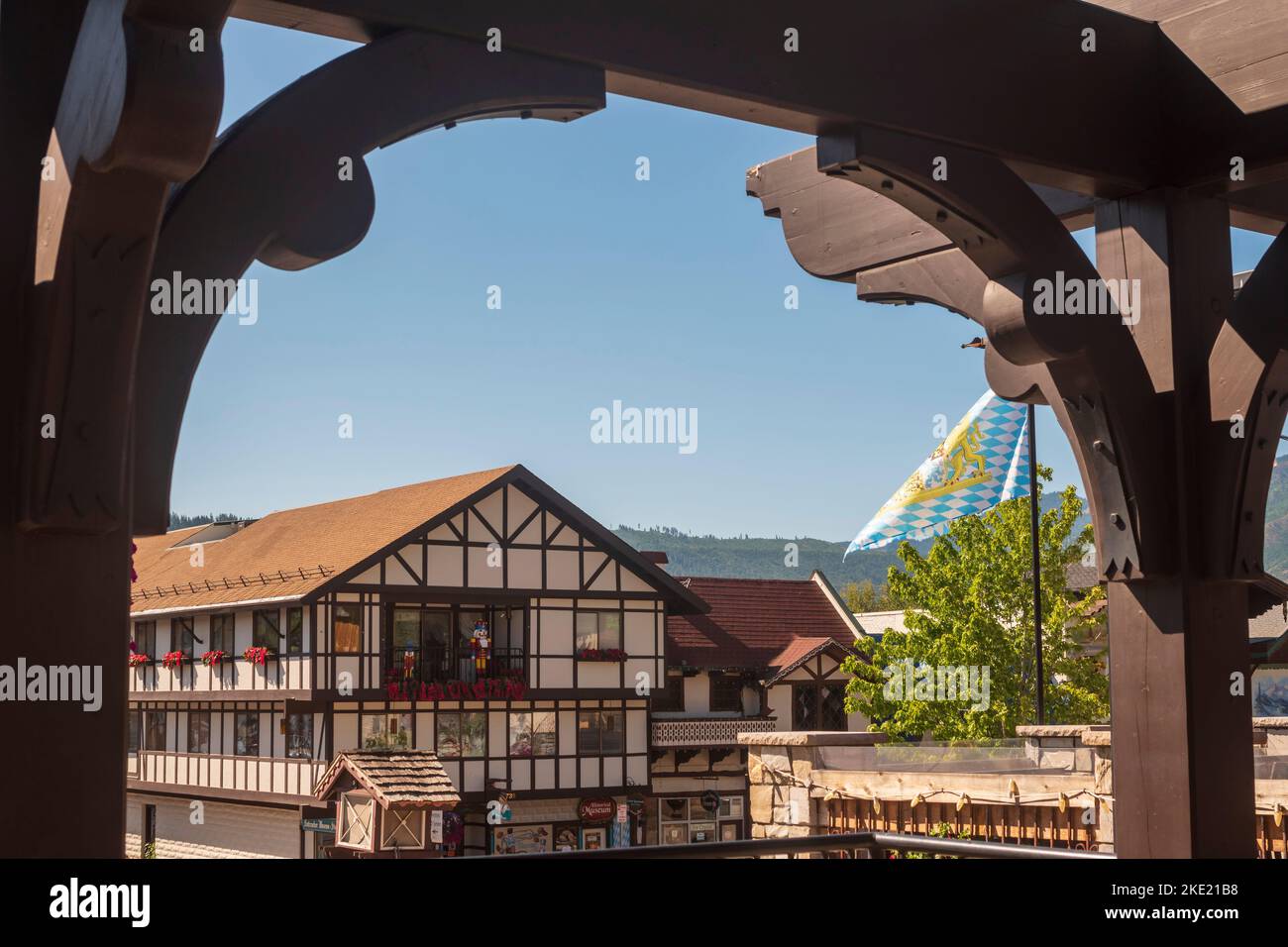 Bavarian style buildings are seen through a decorative arch in the German-themed town of Leavenworth, Washington, USA. Stock Photo