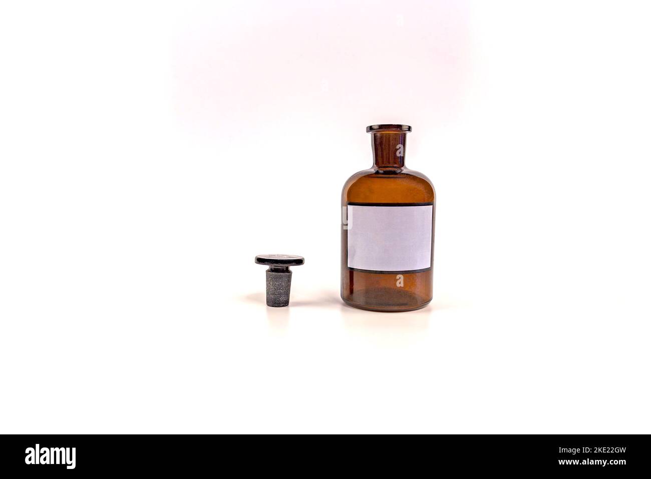 Brown medical jar with a glass stopper on a white background with a