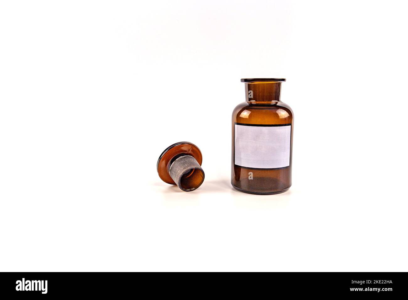 Brown medical jar with a glass stopper on a white background with a