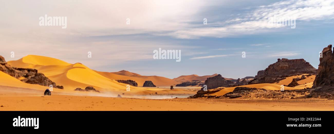 Panoramic view of Sahara Desert sand dune and rocky mountain off road ...