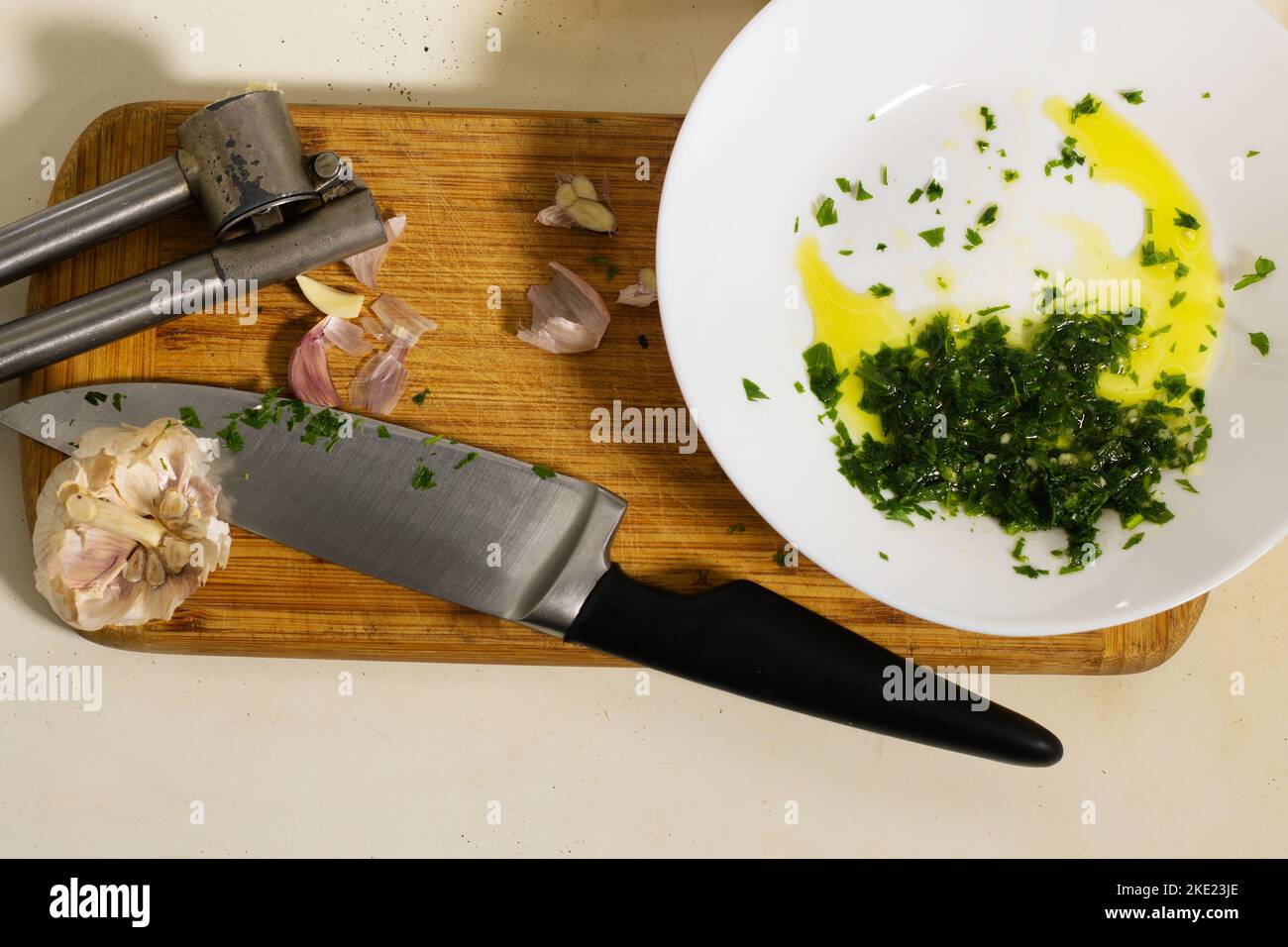 preparing parsley, garlic and olive oil dressing in the kitchen Stock