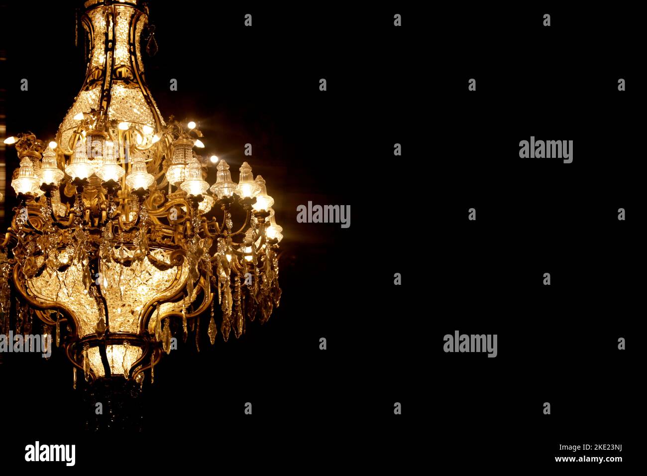 antique crystal chandelier on dark background and writing space Stock Photo