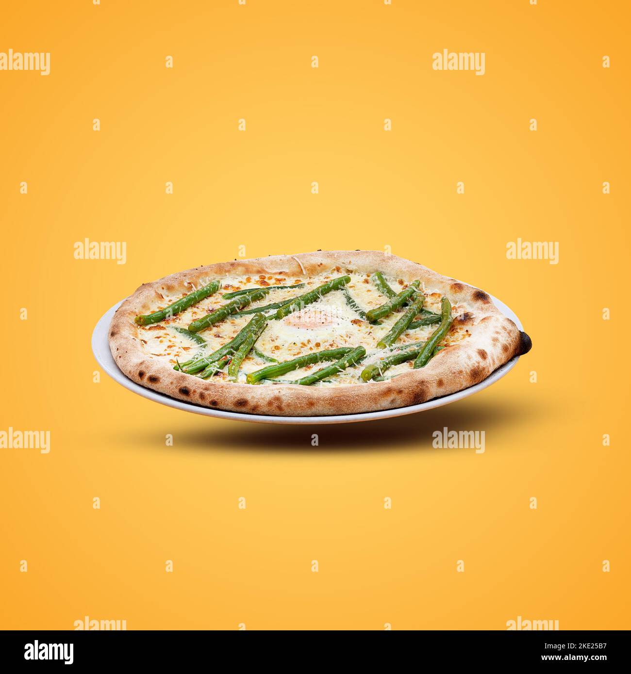 Homemade Italian pizza on a yellow background. Stock Photo