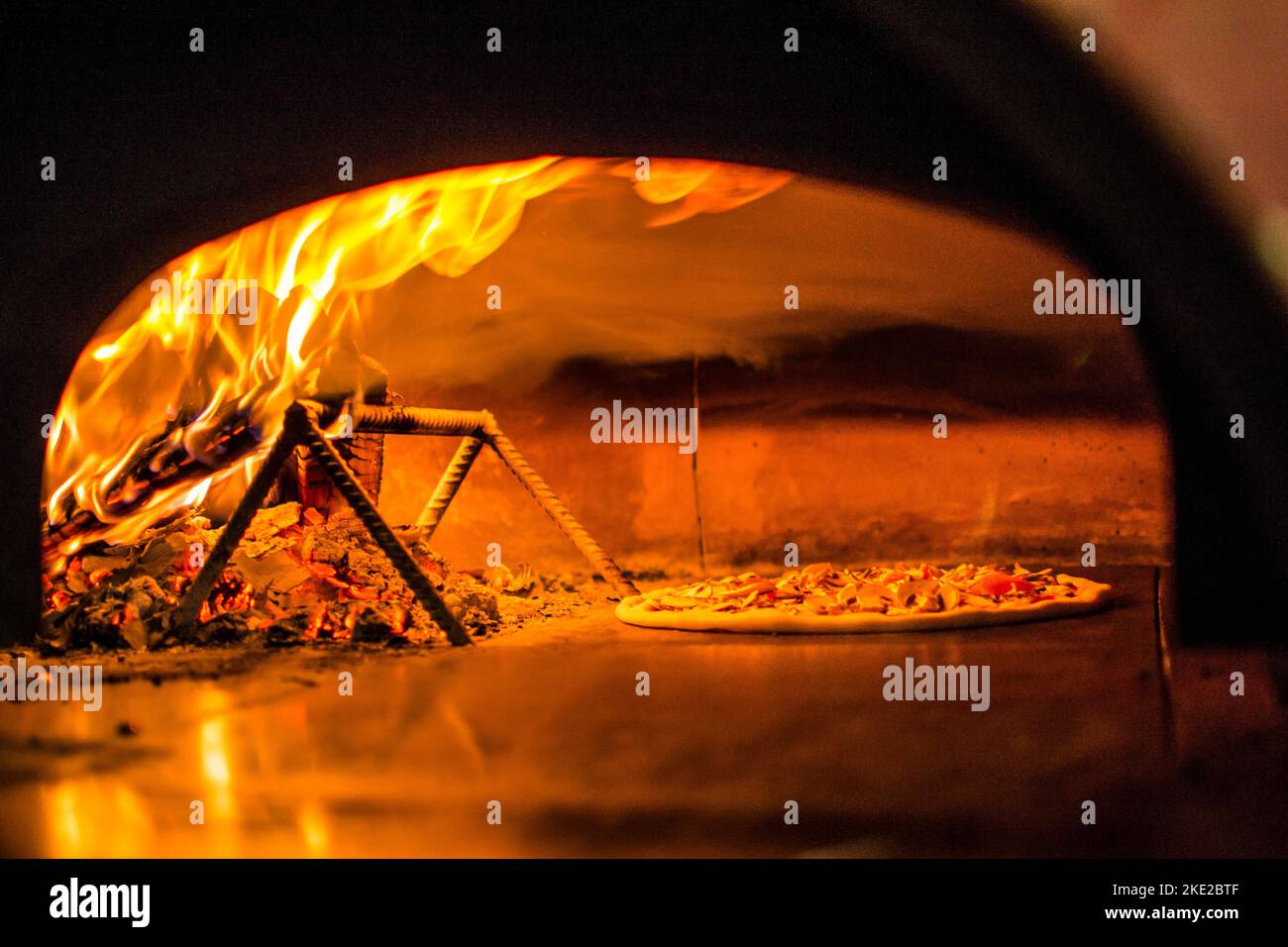 cooking pizza in the oven . Pizza near the stone stove with fire